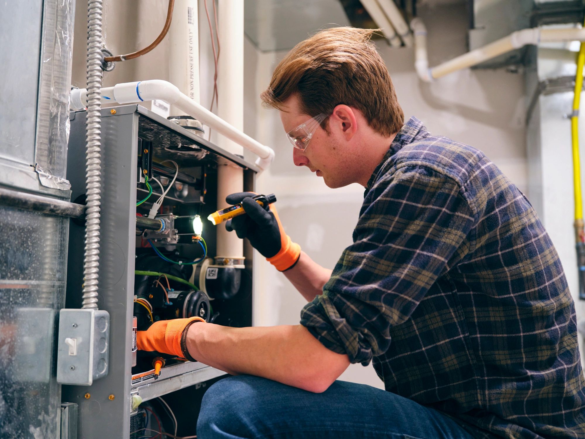HVAC technician servicing a home heating and cooling system