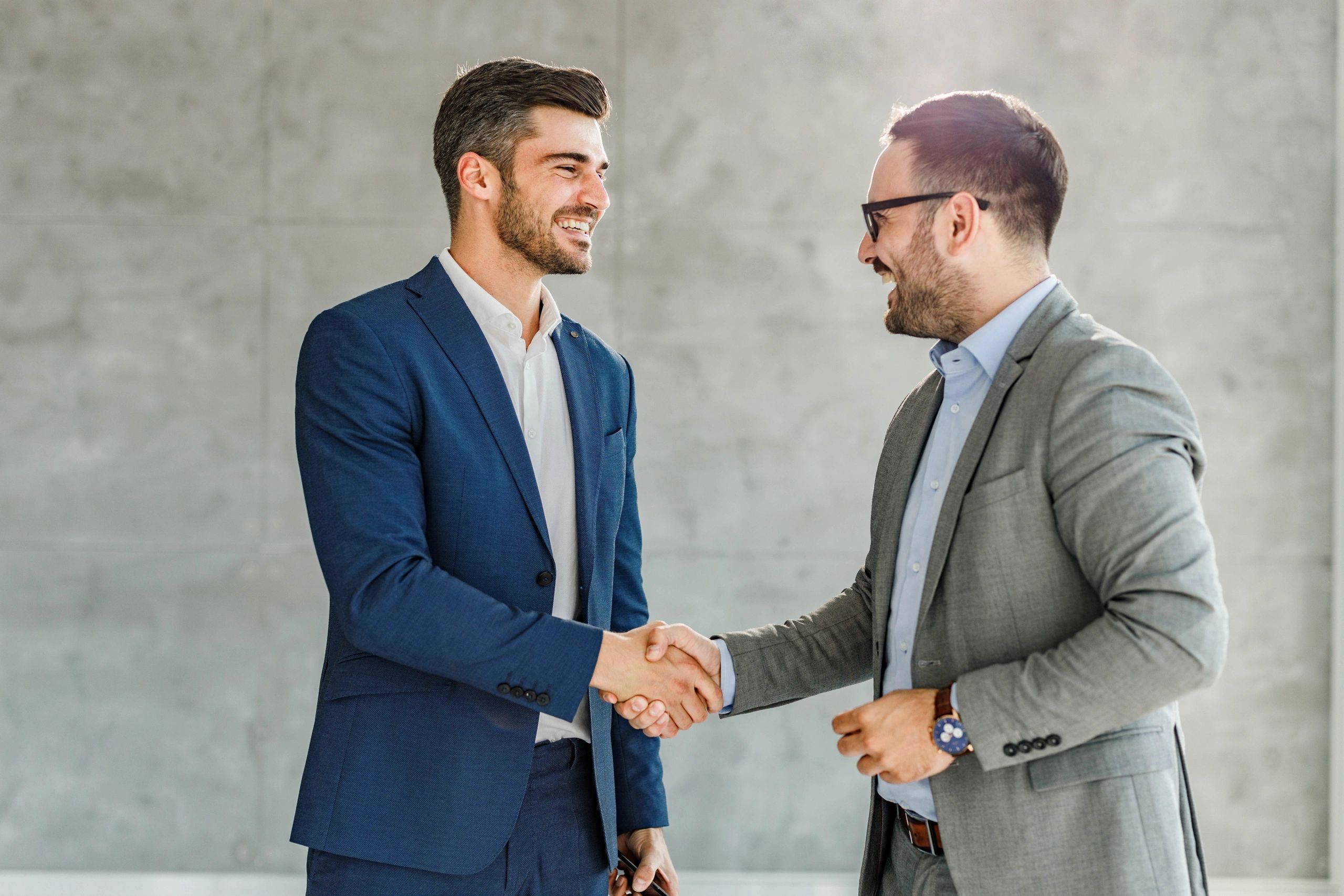 Facility manager shaking hands with contractor in an office