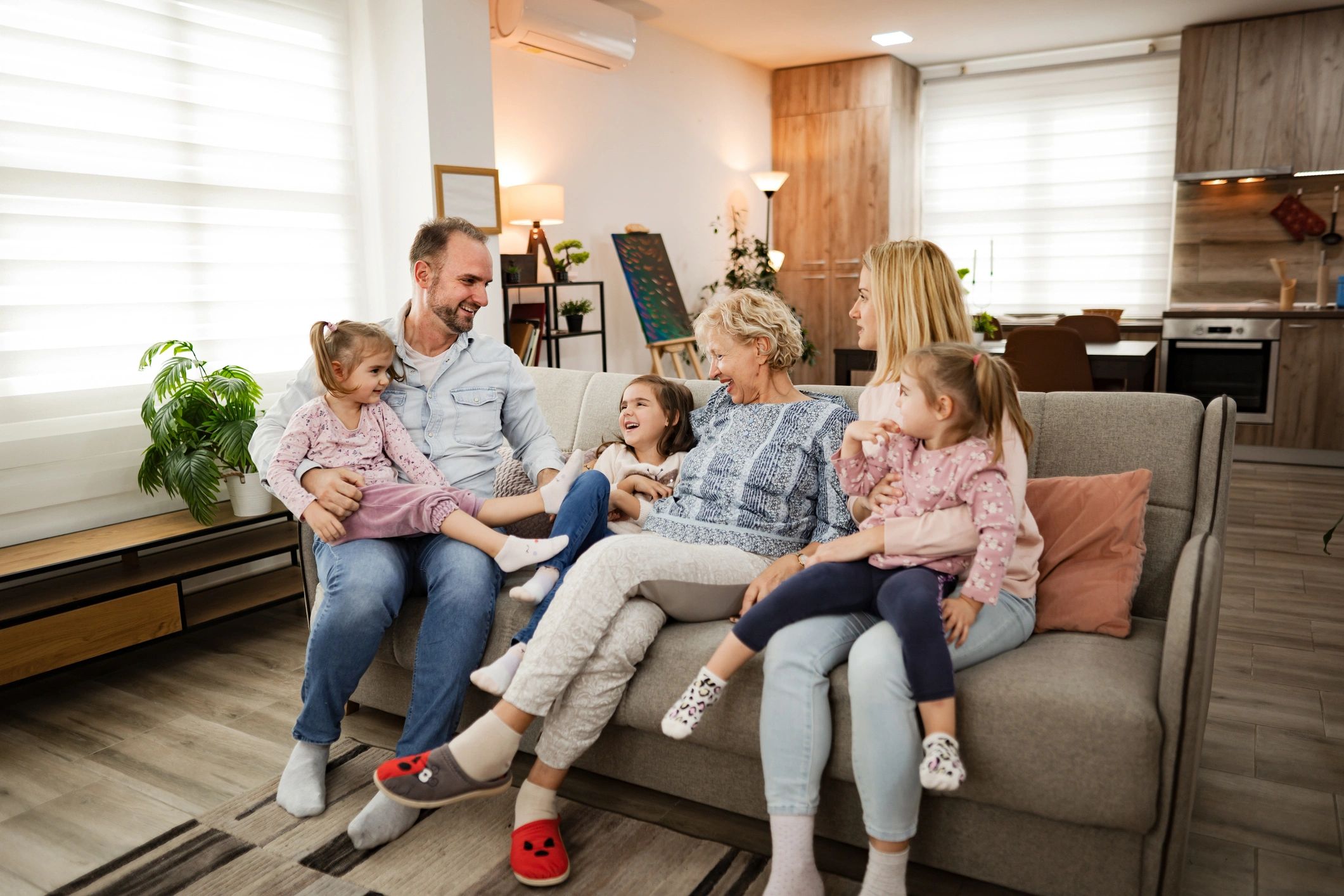 Homeowner smiling on a sofa